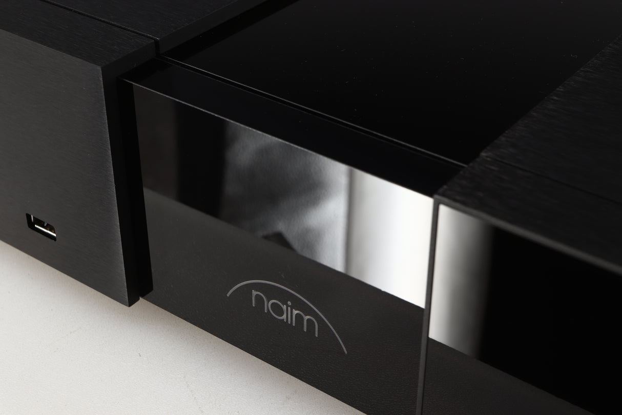 Close up of a used Naim NSC222 Pre Amplifier in a black finish showing scratching on fascia