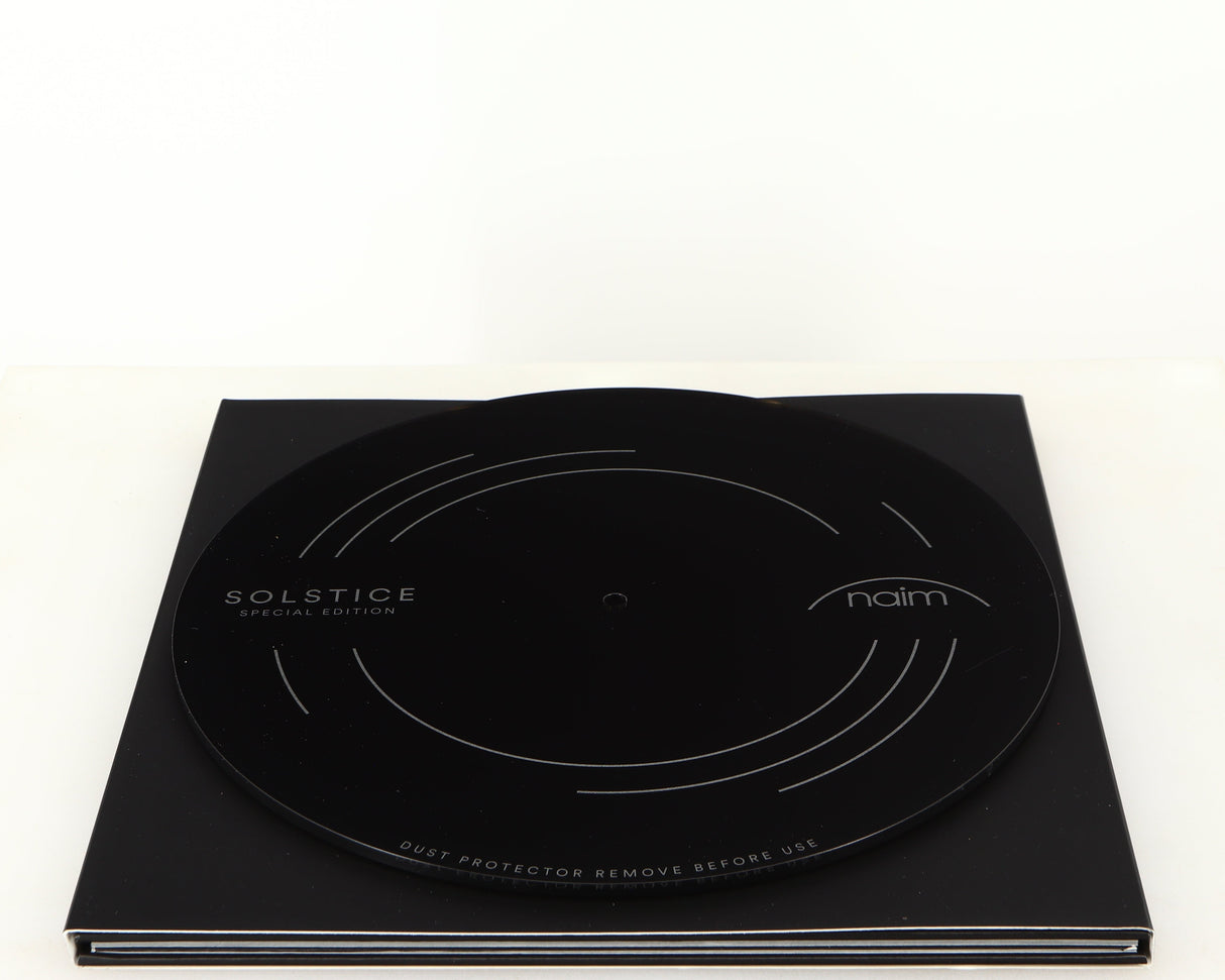 Top of a used Naim Dust Protector and Manual in a black finish