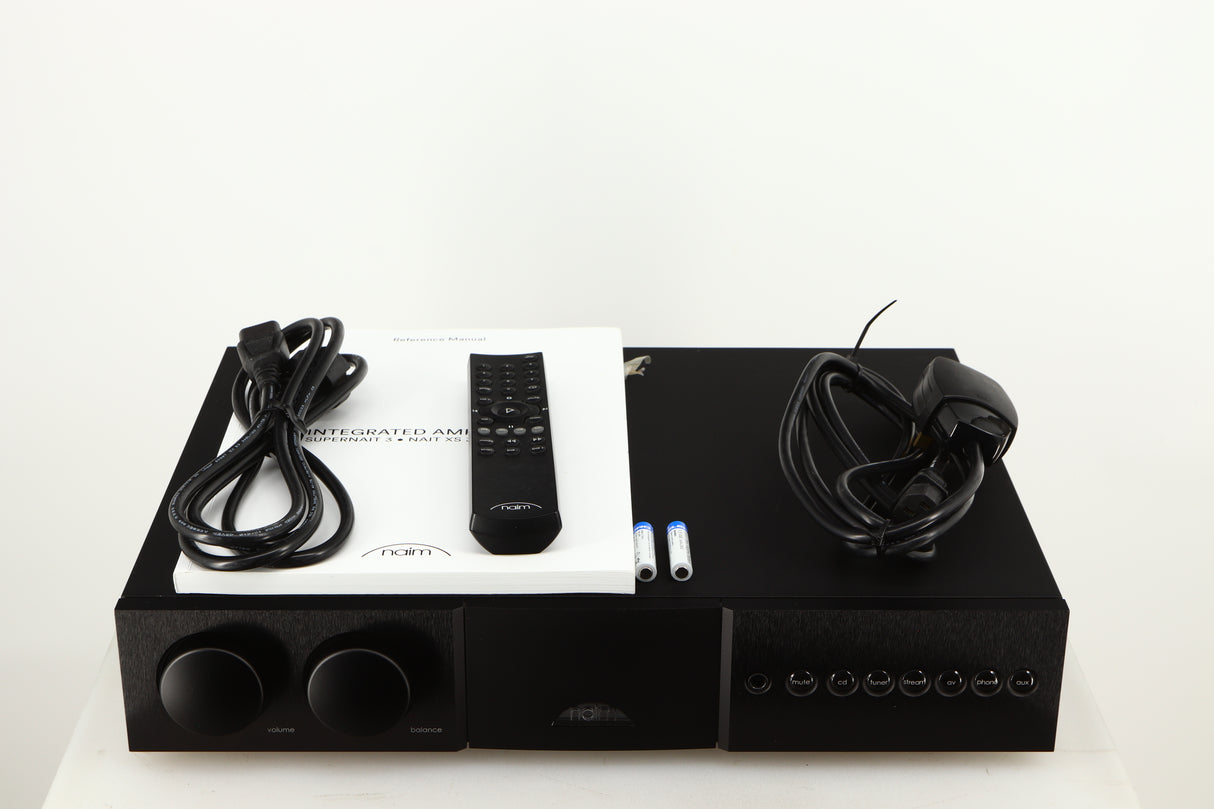 Top of a used Naim Supernait 3 Integrated Amplifier in a black finish showing Mains Cable, Remote, 2x Batteries, Schuko Cable and Manual