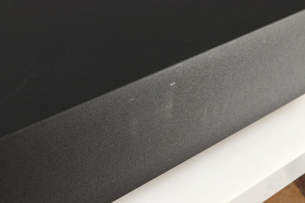 Close up of a used Naim Supernait 3 Integrated Amplifier in a black finish showing some scratching on left side
