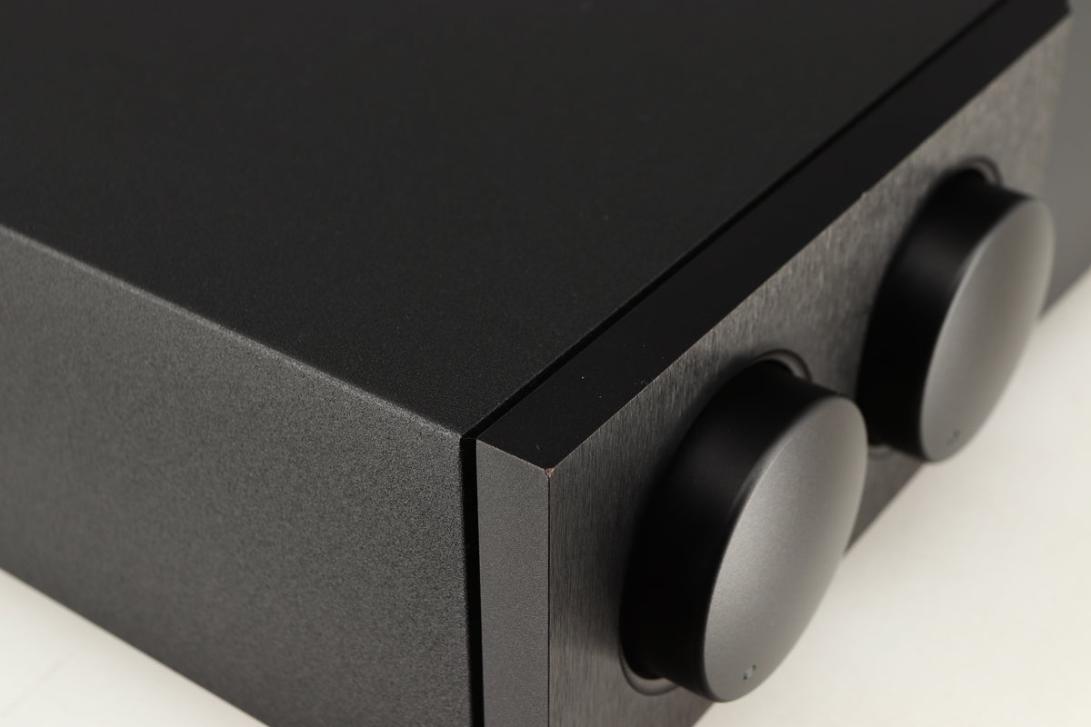 Close up of a used Naim Supernait 3 Integrated Amplifier in a black finish showing small chip on front left corner