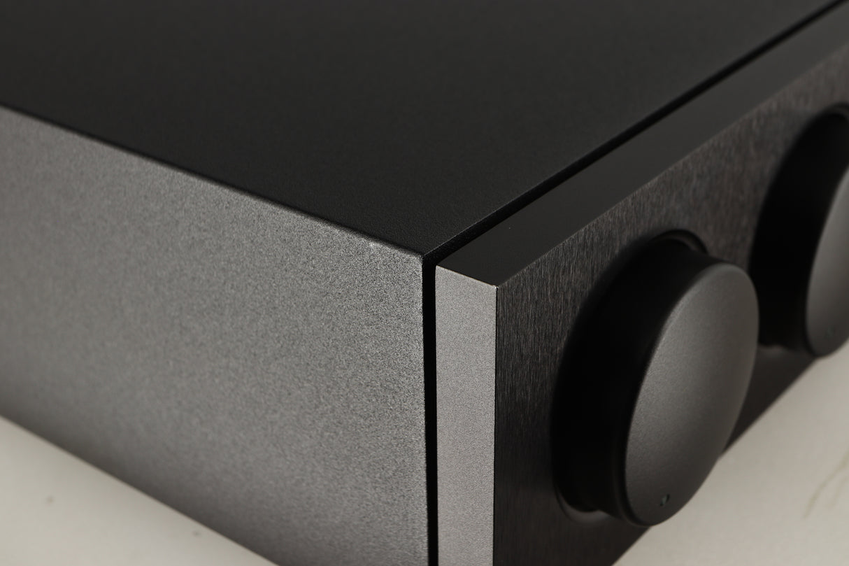 Close up of a used Naim Supernait 3 Integrated Amplifier in a black finish showing very light scratch on left side