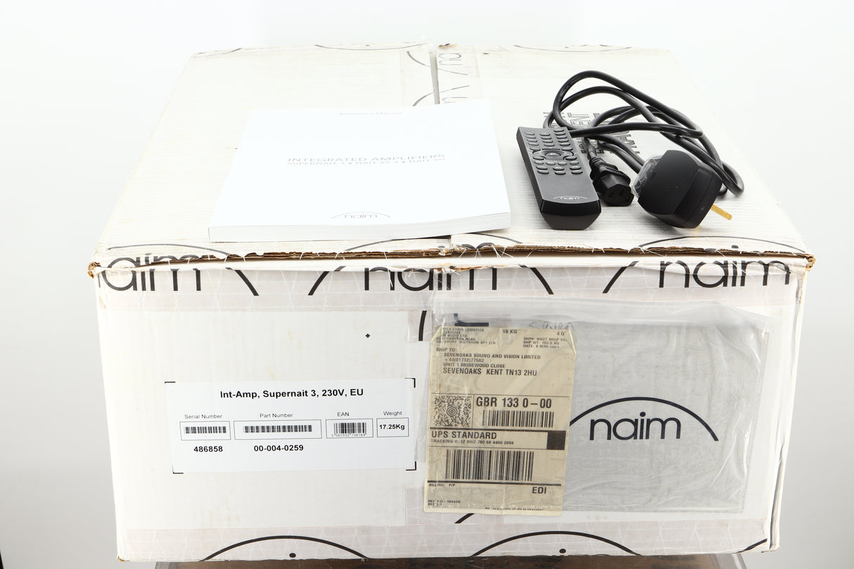 Box of a used Naim SUPERNAIT 3 Integrated Amplifier showing manual, mains cable, and remote