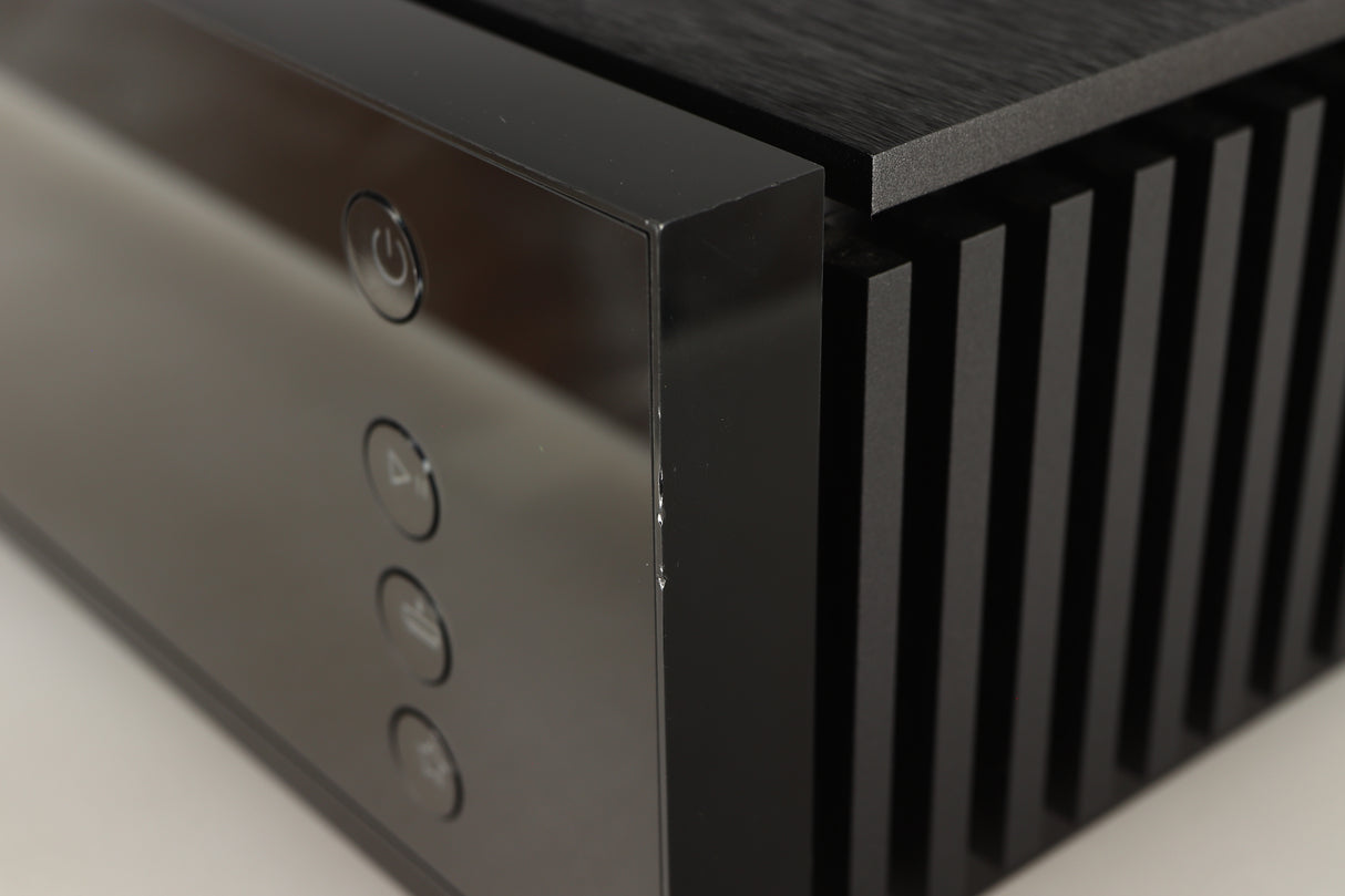 Close up of a used Naim Uniti Atom HDMI Integrated System in a black finish showing nick on front right corner
