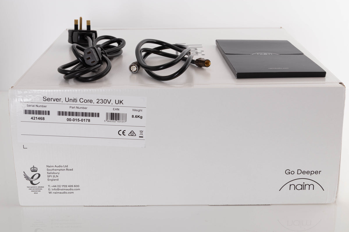Box of a used Naim Uniti Core Server with mains cable, manual, and BNC-RCA cable