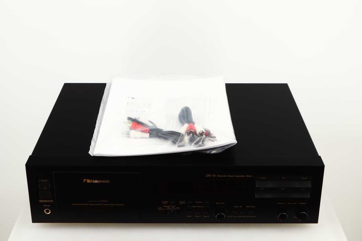 Top of a used Nakamichi DR-10 Cassette Deck in a black finish showing Manual and 2x Interconnect Cables