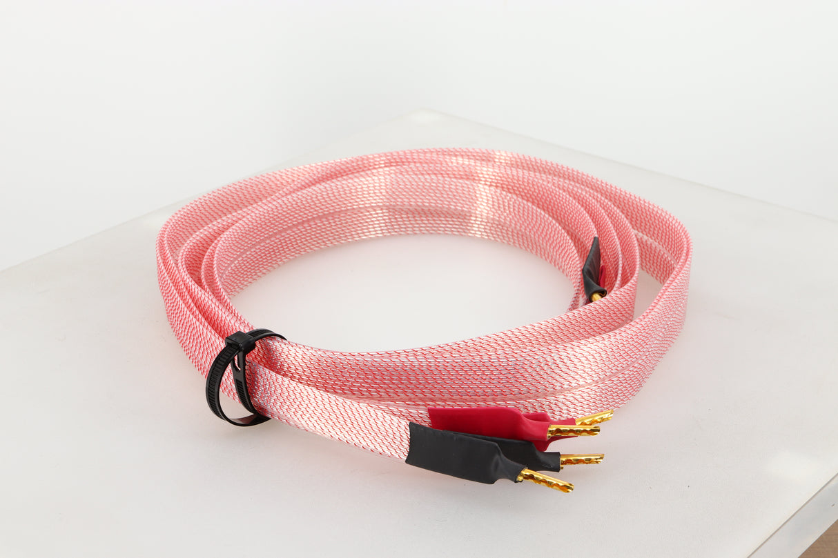 Front left angle of a used Nordost Heimdall 2 Speaker Cables 2.0m Pair in a pink finish