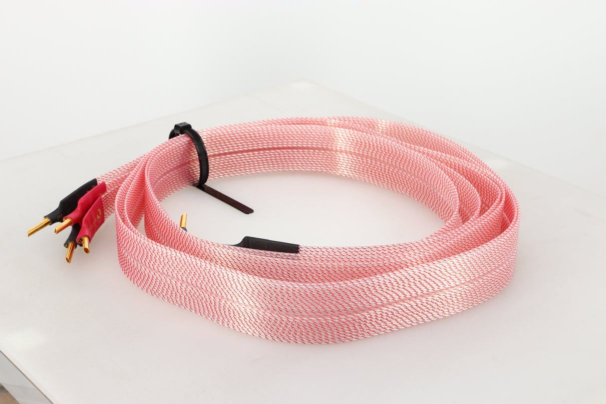 Front right angle of a used Nordost Heimdall 2 Speaker Cables 2.0m Pair in a pink finish
