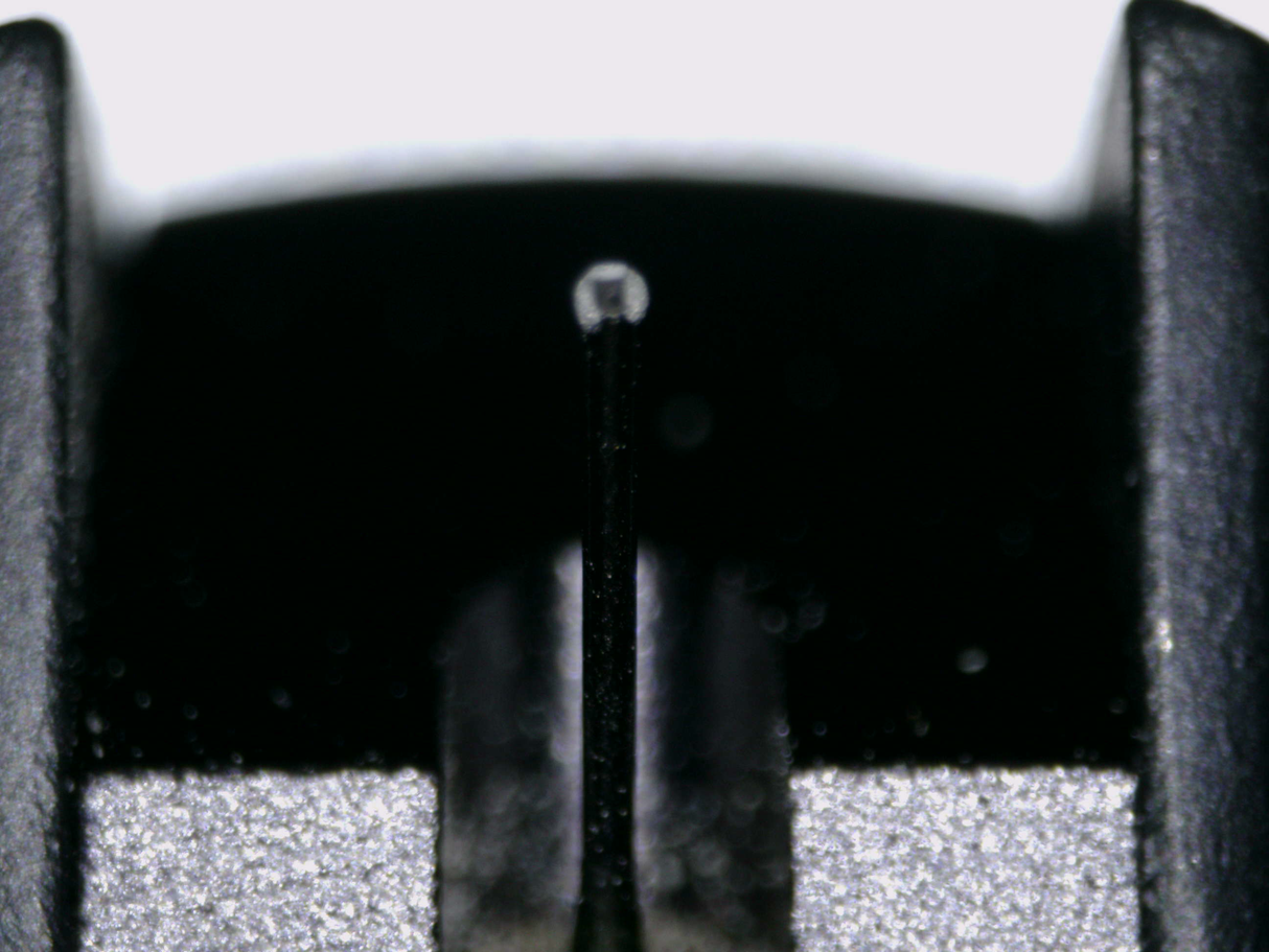 Close up of a used Ortofon Cadenza MC Cartridge in a black finish showing stylus