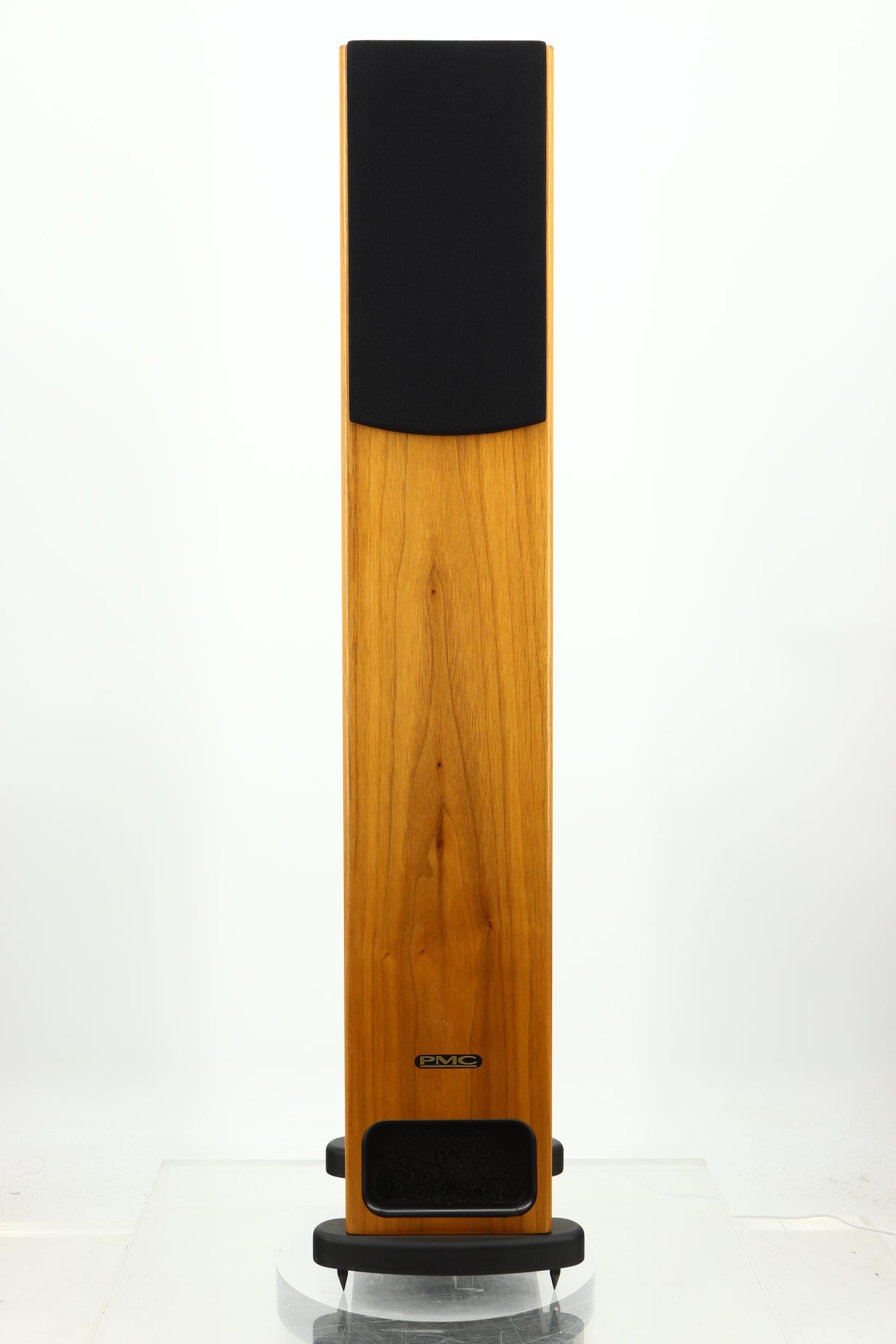 Front view of a PMC GB1 Floorstanding Speaker in a oak finish showing a grille