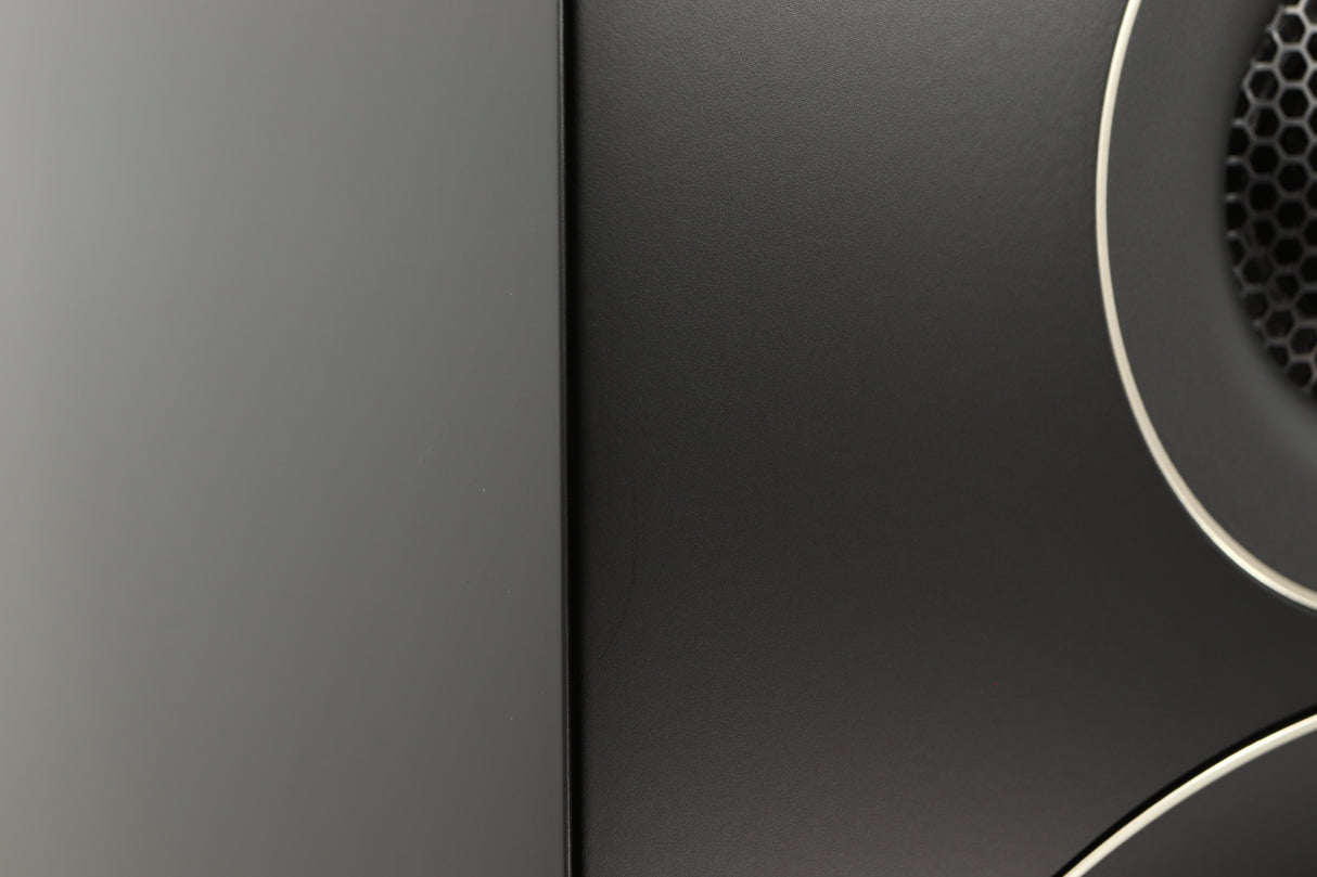 Close up of a used PMC Prodigy 1 Standmount Speakers in a black finish showing some scratching