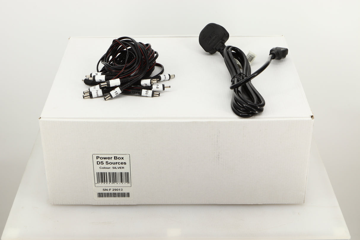 Box of a used Pro-Ject Power Box DS Sources Power Supply in Silver finish showing Mains cable, and connecting cables