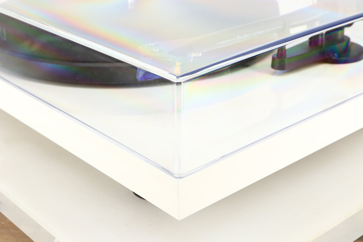 Front right corner of a used Project Debut Carbon Turntable / Ortofon 2M Blue Cartridge in a white finish