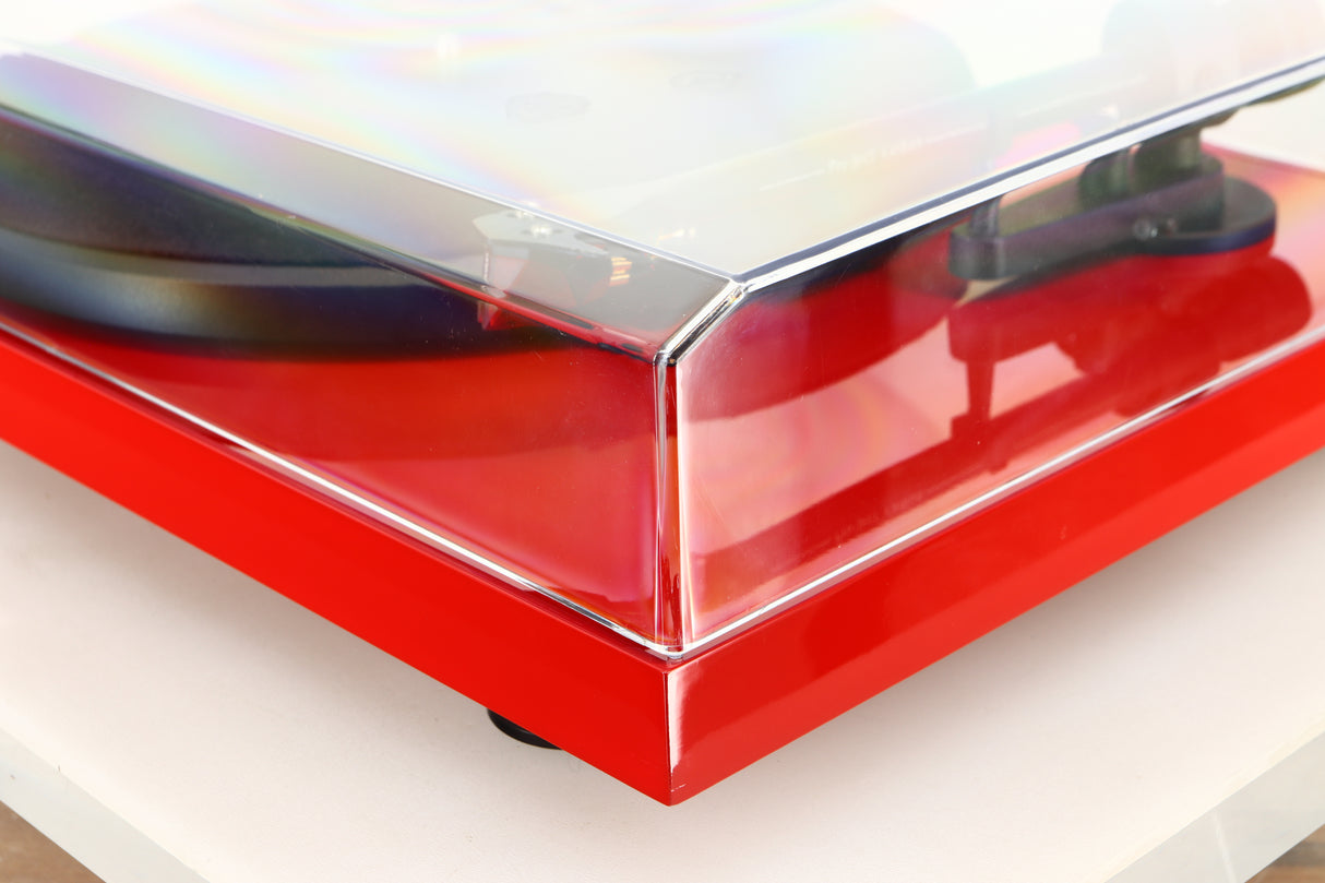Front right corner of a used Project Debut Carbon Turntable in a red finish