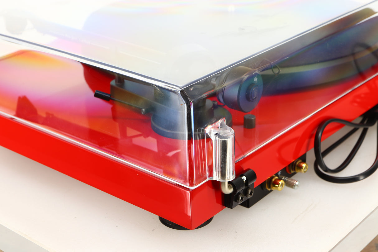 Rear right corner of a used Project Debut Carbon Turntable in a red finish