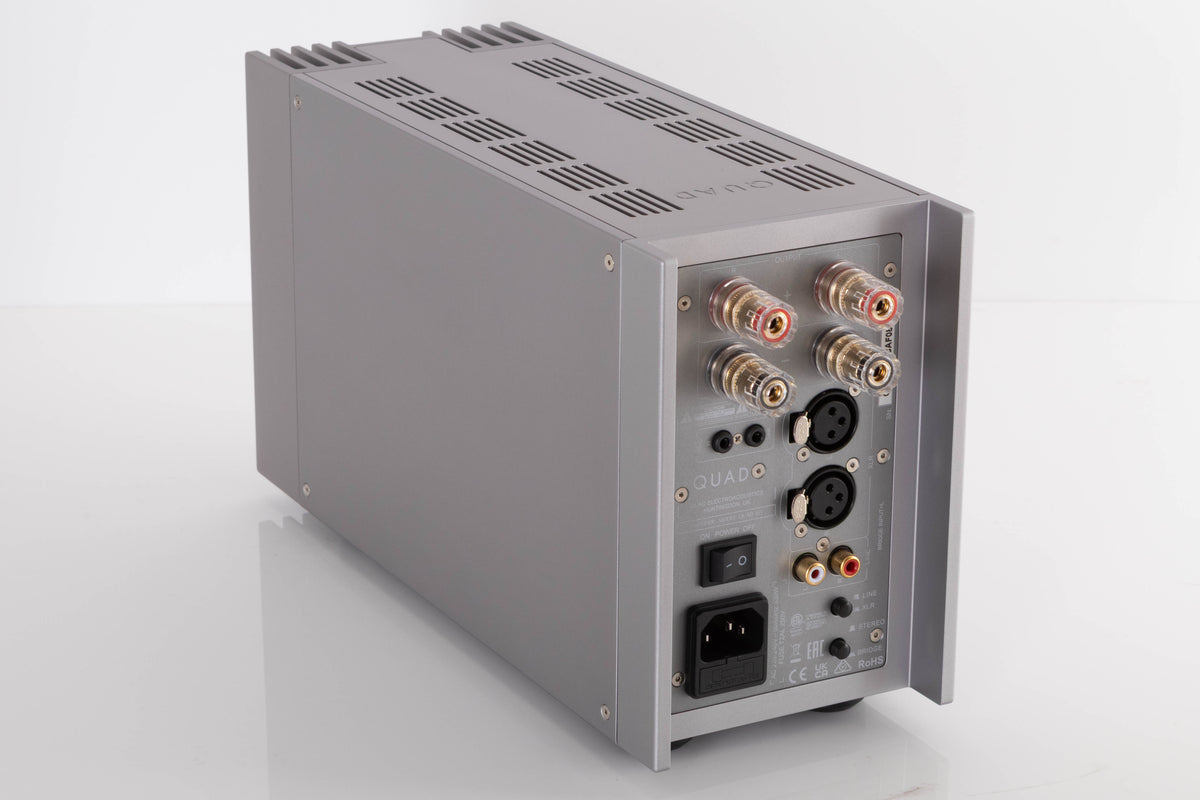 Rear right corner of a used Quad 303 Power Amplifier in a Silver finish