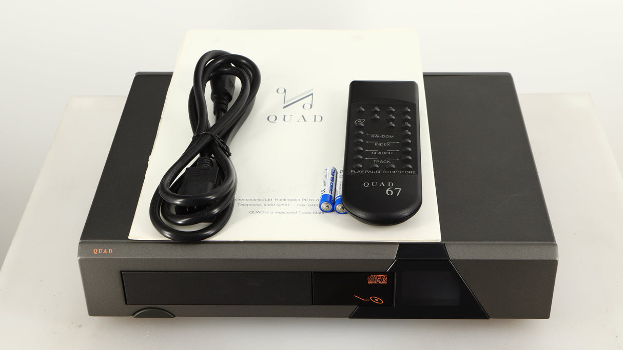 Top of a used Quad 67 CD Player showing Mains Cable, Remote, Batteries and Manual