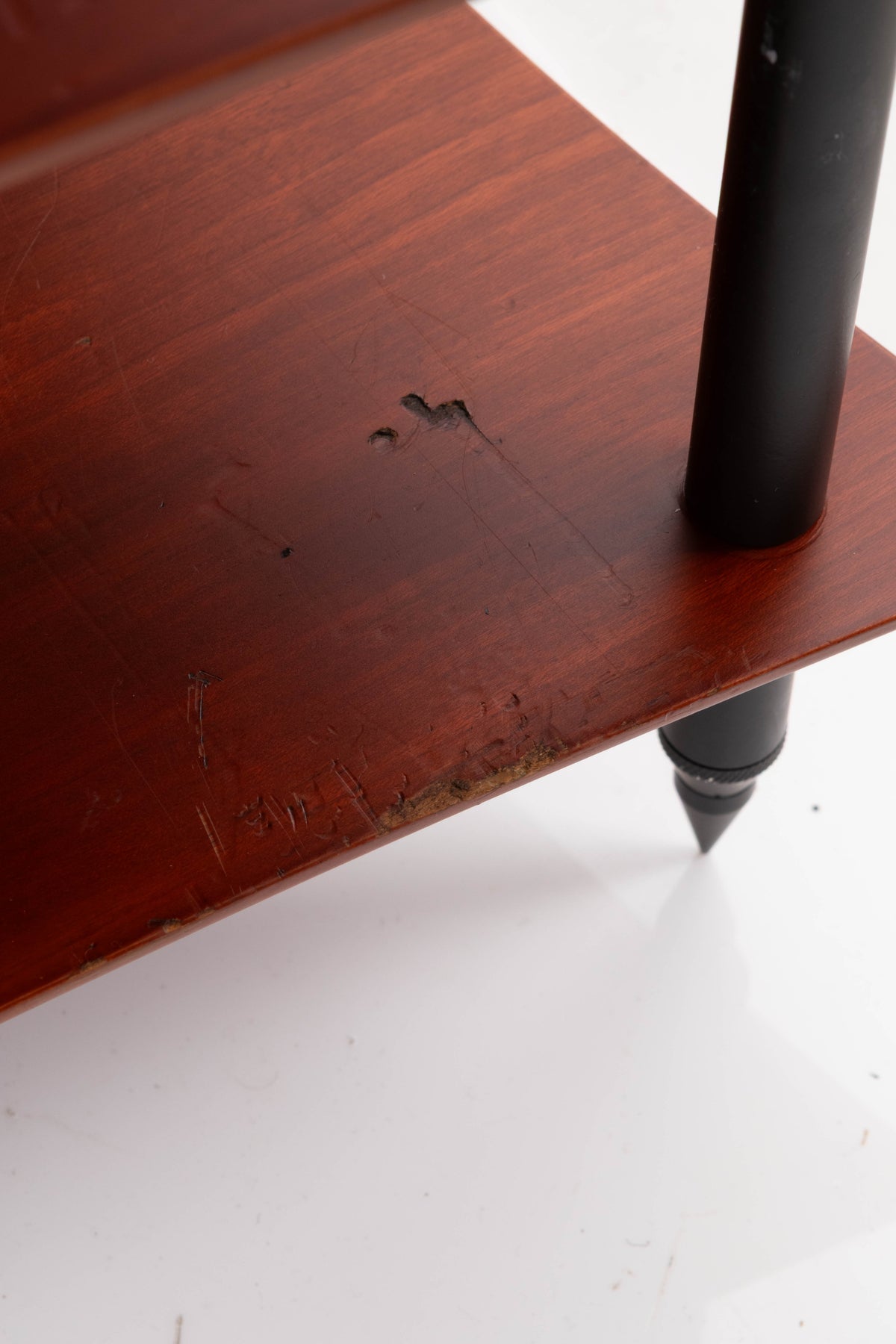 Close up of a used Quadraspire 4 Shelf Hifi Stand in a Dark Cherry / Black finish showing damage on stand