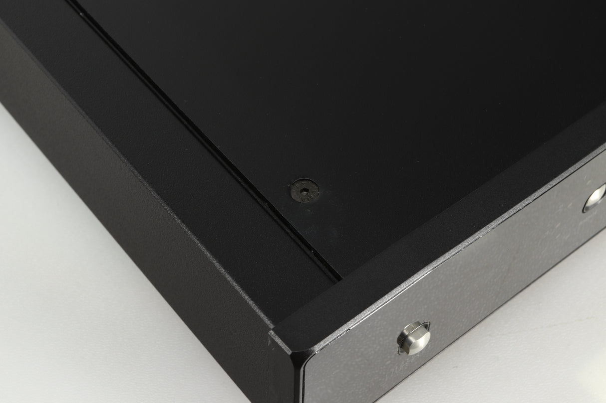 Close up of a used Rega Brio-R Integrated Amplifier in a black finish showing a mark on top