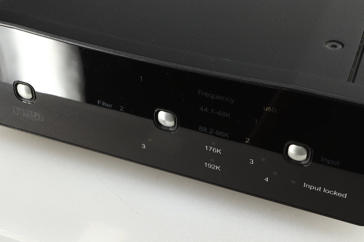 Close up of a used Rega DAC-R Digital Analogue Converter in a black finish showing scratching on the screen