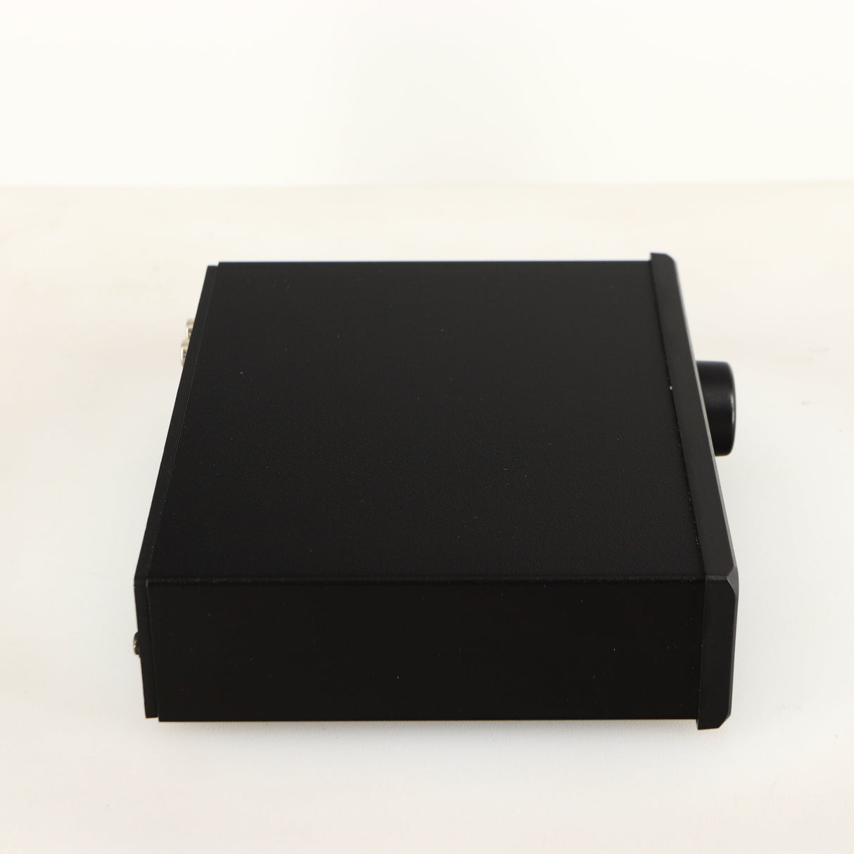 Left side view of a used Rega EAR Headphone Amplifier in a black finish