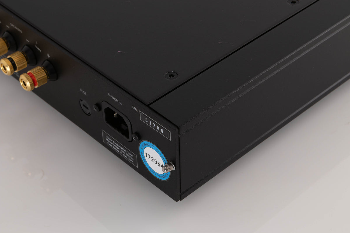 Rear left corner of a used Rega Elex MK4 Integrated Amplifier in a Black finish