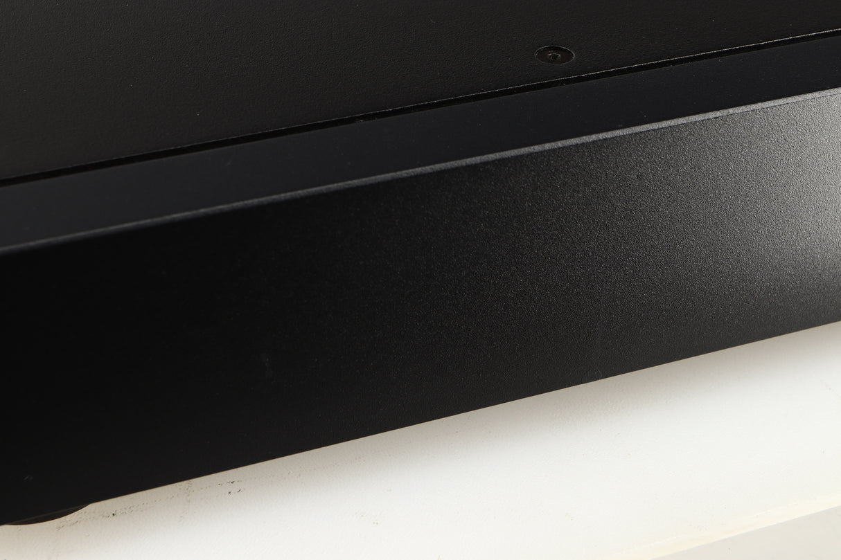 Close up of a used Rega Elex-R Integrated Amplifier in a black finish showing marks on right side