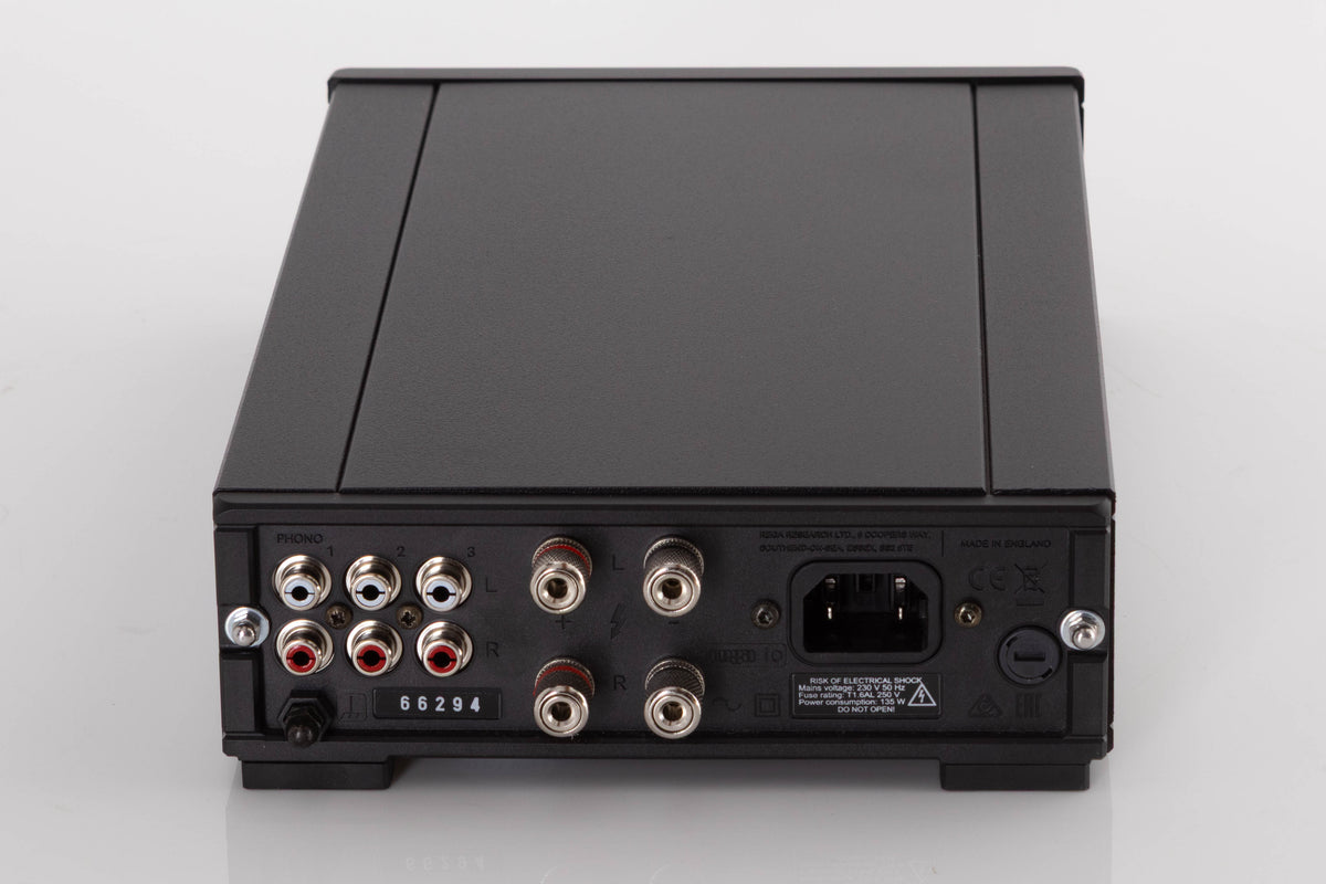 Rear view of a used Rega IO Integrated Amplifier in a Black finish showing Mains Input and Phono Inputs