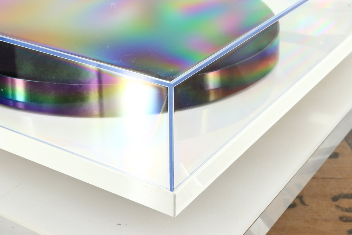 Front left corner of a used Rega Planar 1 Plus Turntable in a white finish