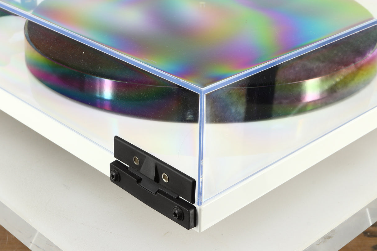 Rear left corner of a used Rega Planar 1 Plus Turntable in a white finish