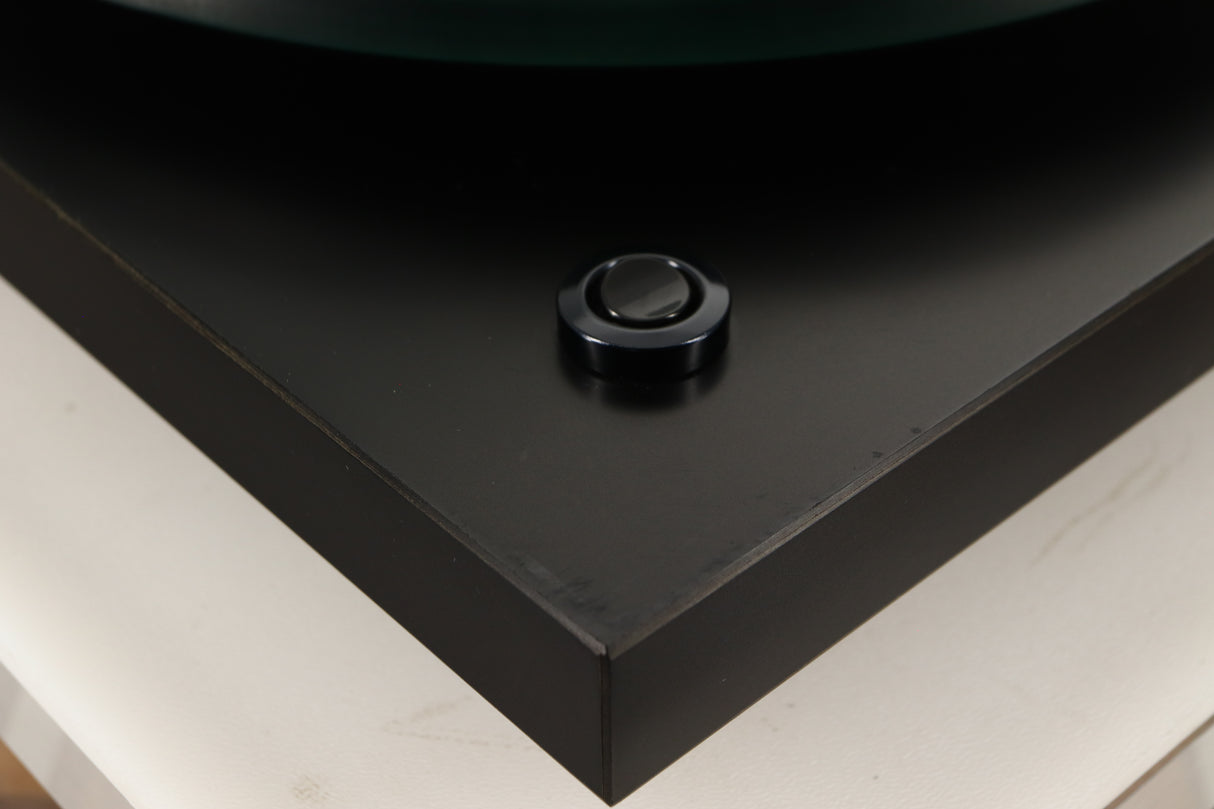 Close up of a used Rega Planar 3 (24V Motor Upgraded) Turntable / Grado F3+ Cartridge in a black finish showing scratching on plinth