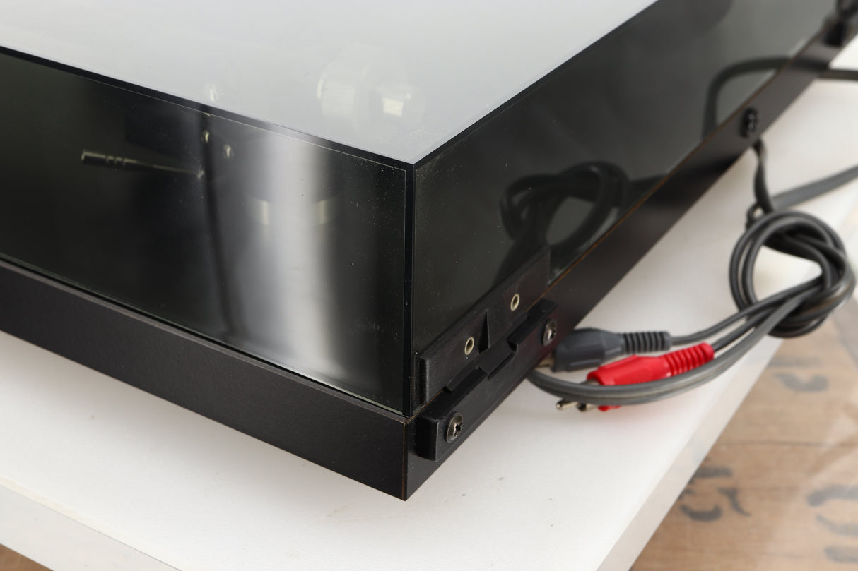 Rear right corner of a used Rega Planar 3 Turntable 24V Upgraded in a black finish