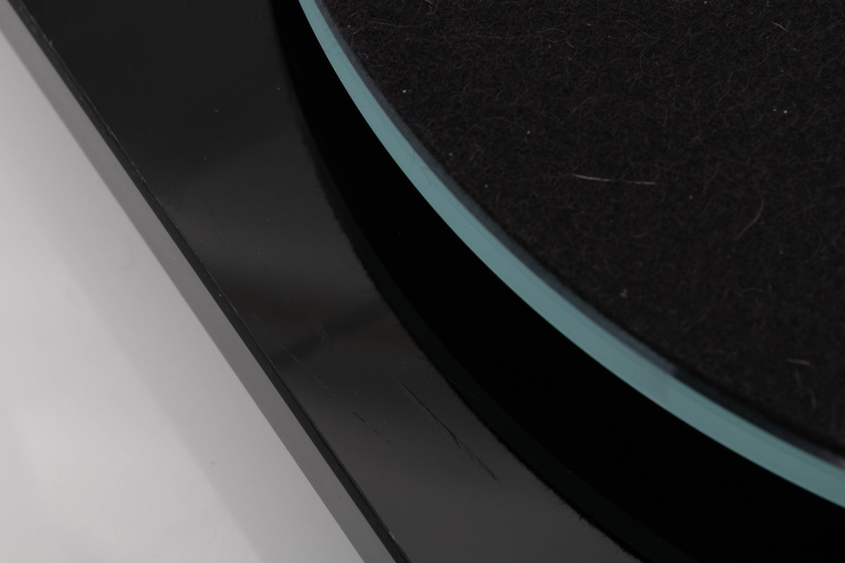 Close up view of a used Rega Planar 3 Turntable in Gloss Black with Elys Cartridge