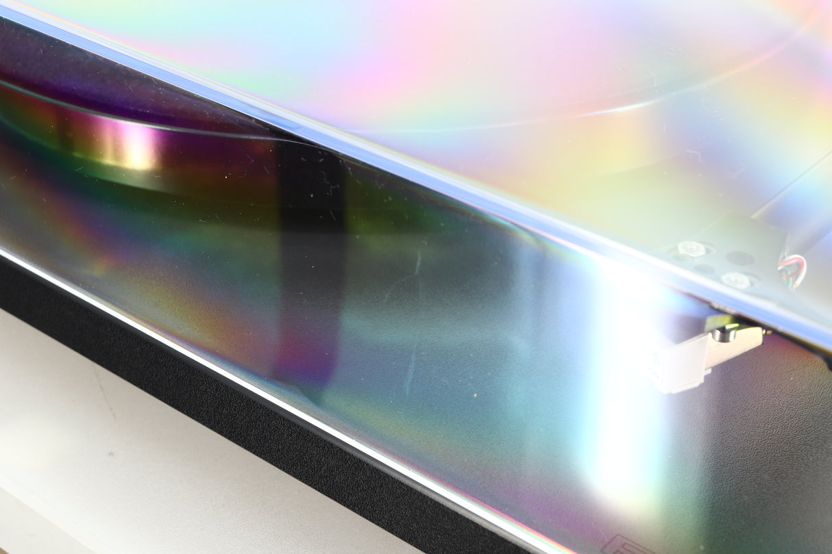 Close up of a used Rega Planar RP1 Turntable in a cool grey finish showing a scratch on the lid
