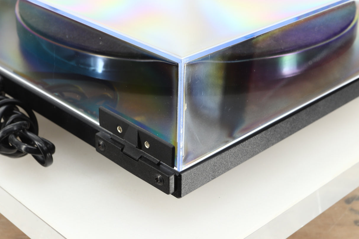 Rear left corner of a used Rega Planar RP1 Turntable in a cool grey finish