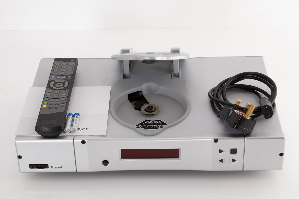 Top of a used Rega Planet CD Player in a Silver finish showing Mains Cable, Remote, Batteries and Manual