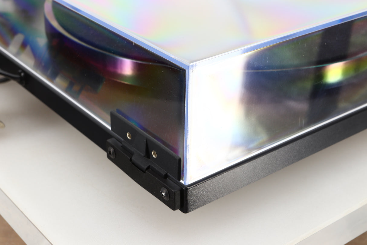Rear left corner of a used Rega RP1 Turntable in a cool grey finish