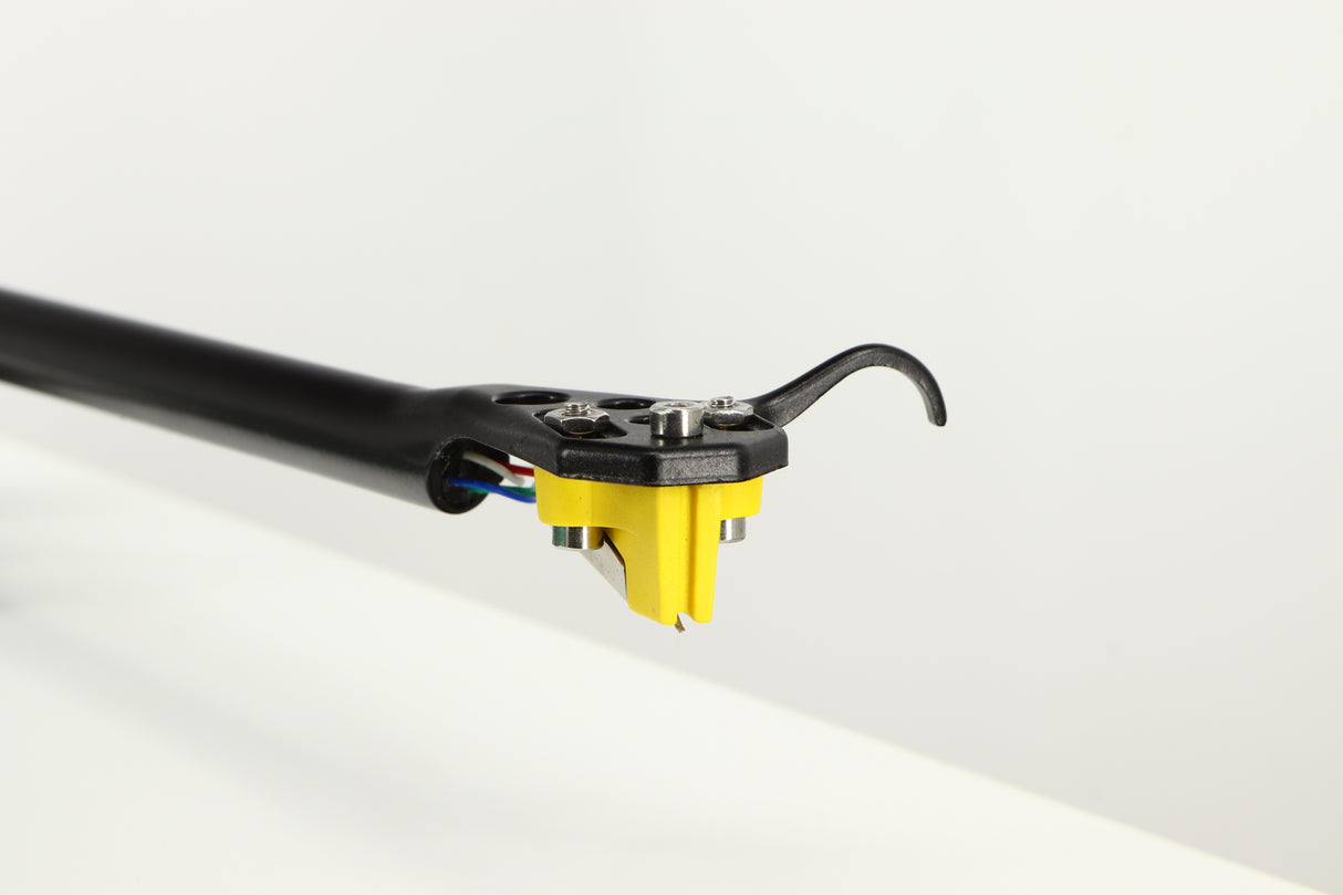 Close up of a used Rega RP3 / Exact Cartridge in a white finish showing stylus