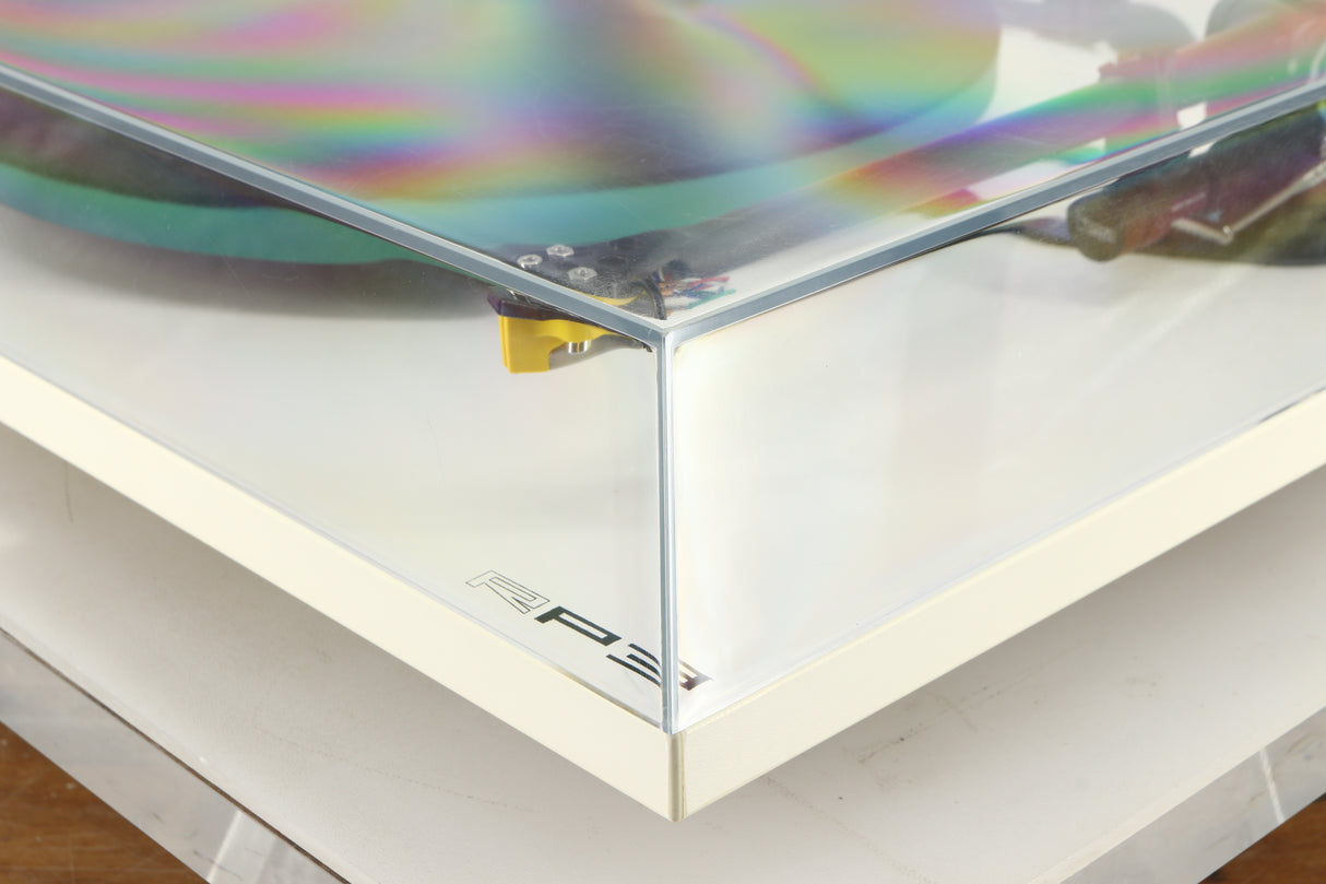 Front right corner of a used Rega RP3 / Exact Cartridge in a white finish