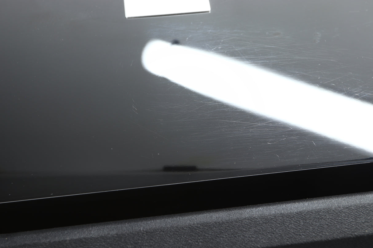 Close up view of a used REL S/3 SHO Subwoofer in Piano Black finish showing scratching on the top