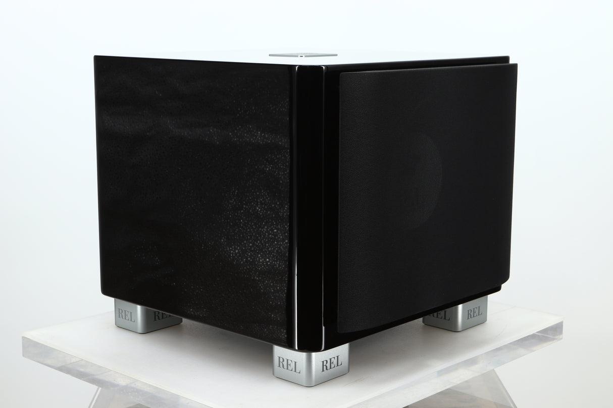 Front left corner of a used REL T-7X Subwoofer in a piano black finish