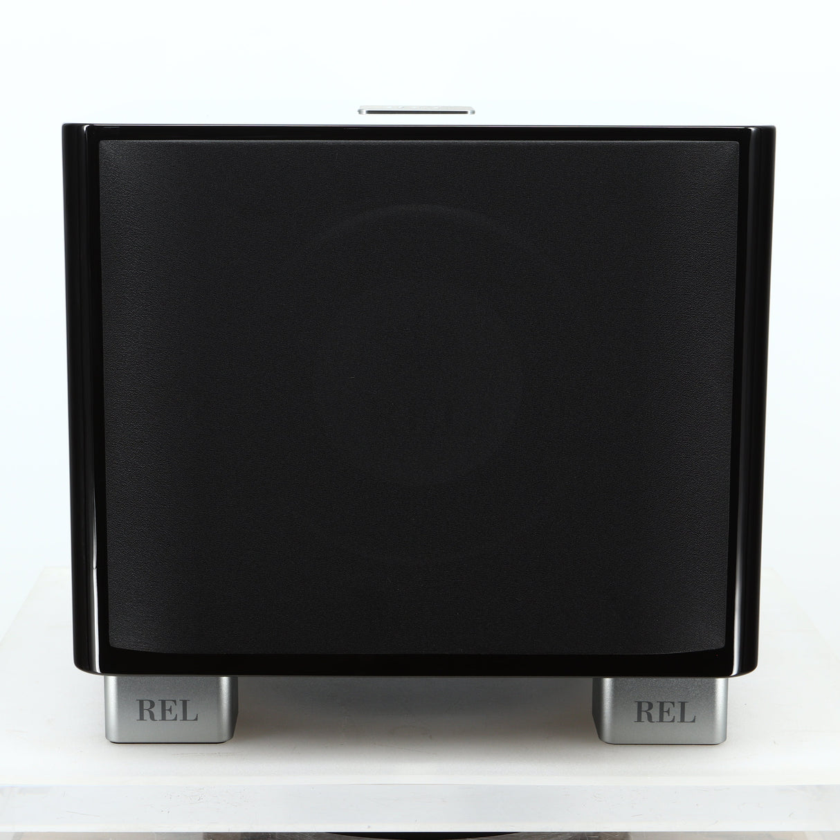 Front view of a used REL T-7X Subwoofer in a piano black finish showing the grille