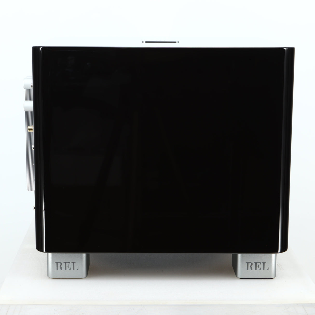 Left side view of a used REL T-7X Subwoofer in a piano black finish