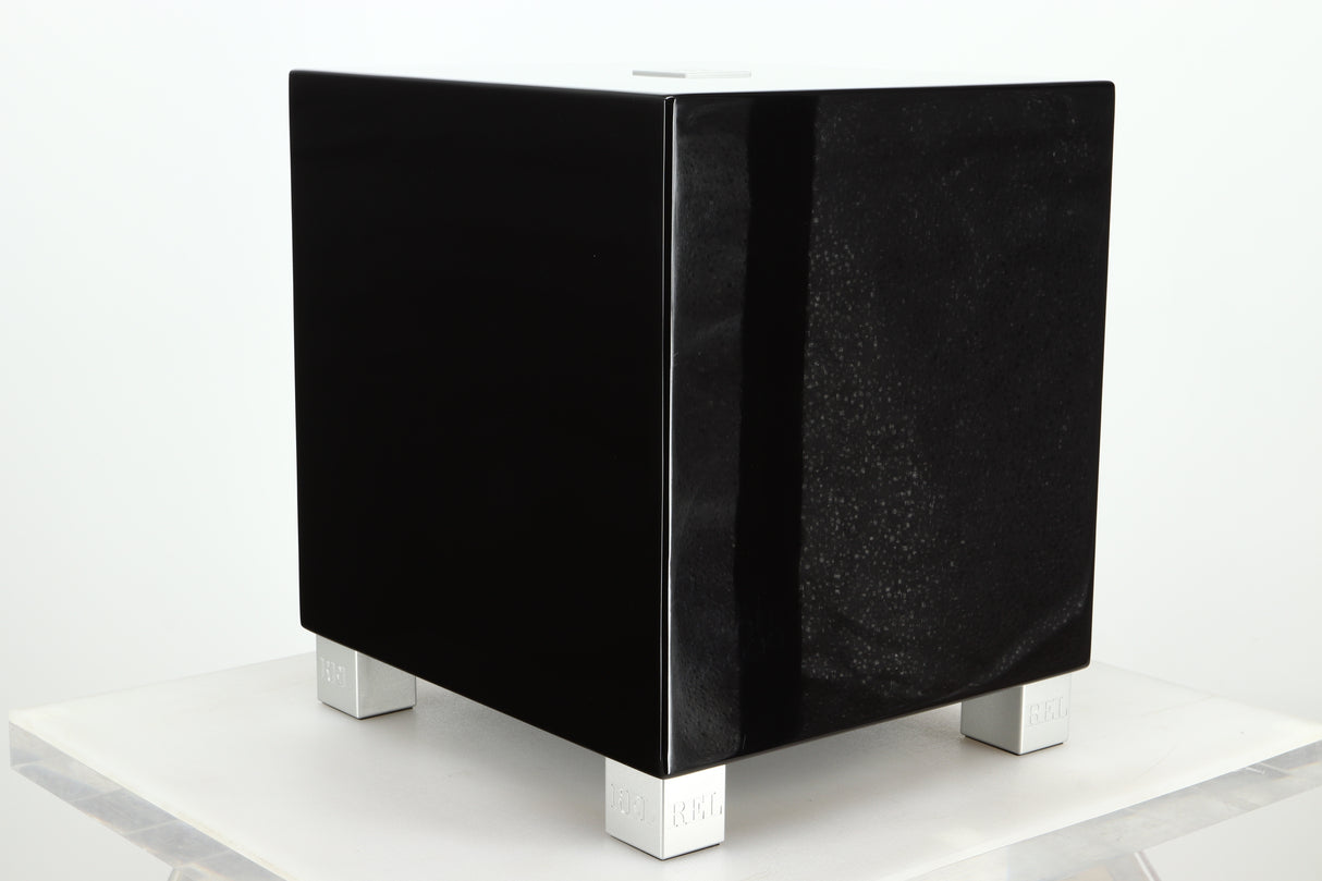 Front left corner of a REL T5i Subwoofer with a piano black finish