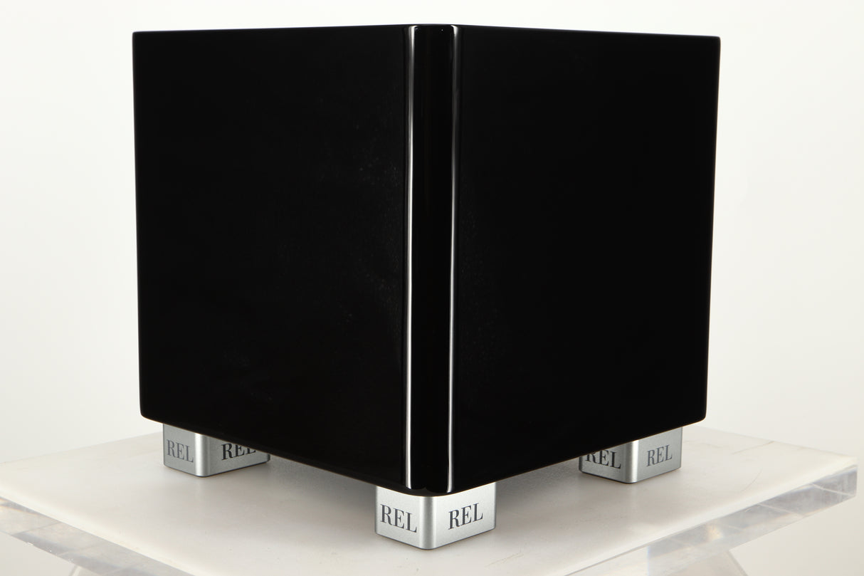 Front left corner view of a used REL T5X Subwoofer in Piano Black finish