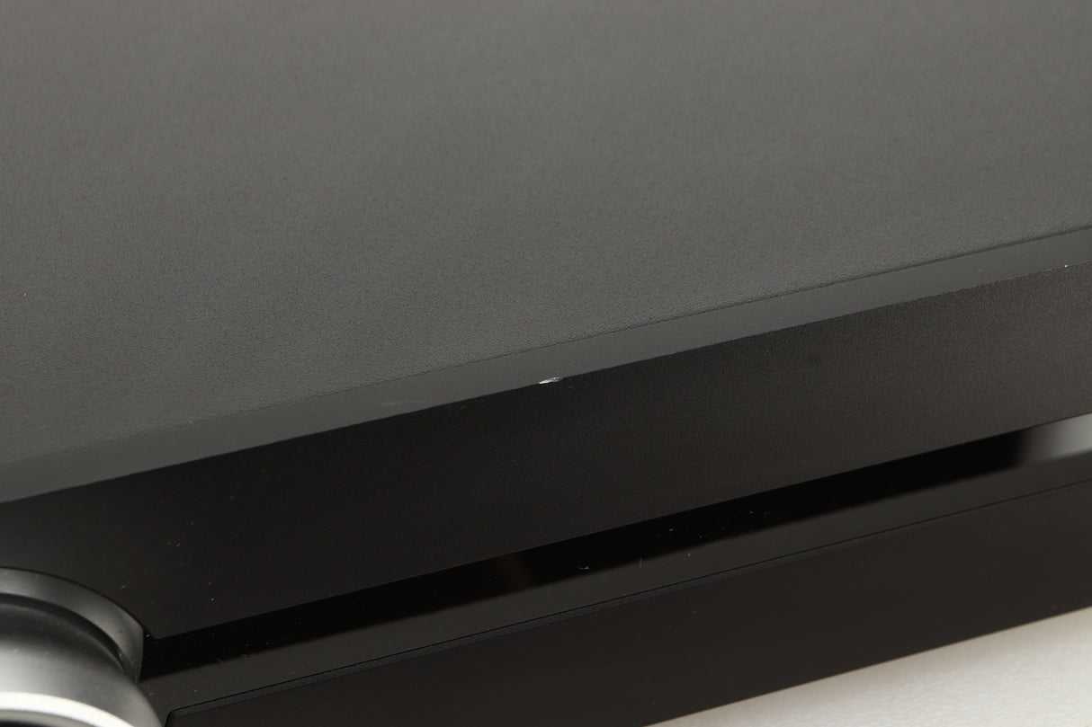 Close up view of a used Roksan Attessa Integrated Amplifier in Black finish showing a small chip on the front edge