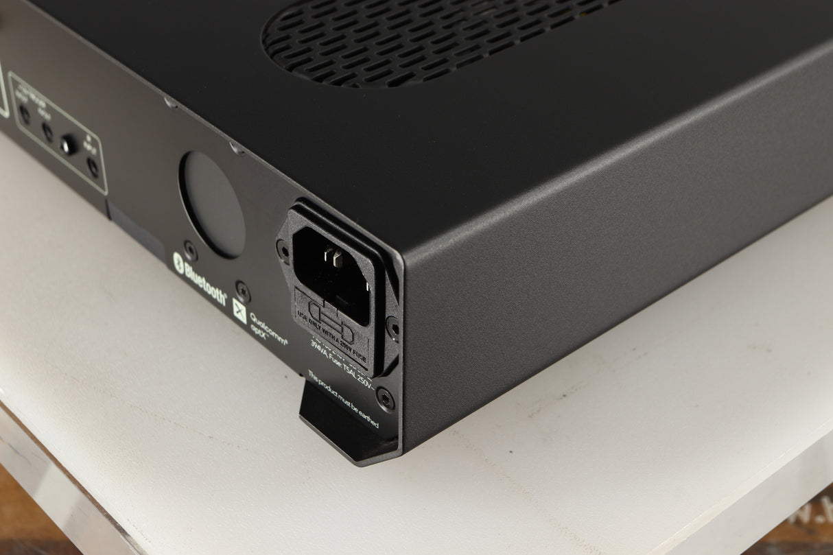 Rear left corner of a used Roksan Attessa Integrated Amplifier in a black finish