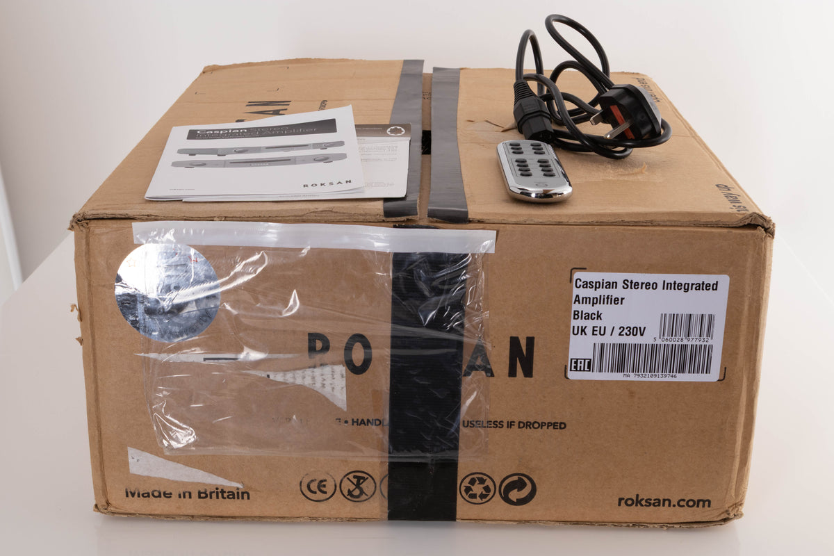 Box of a used Roksan Caspian M2 Integrated Amplifier in Black with mains cable, remote, and manual