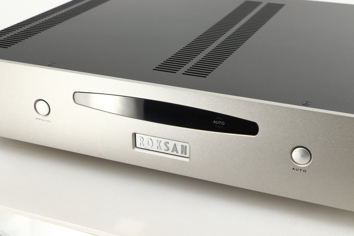 Close up of a used Roksan Caspian MSeries-1 Power Amplifier in a silver finish showing some of the fascia