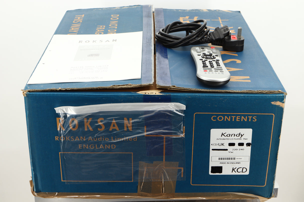 Box of a used Roksan Kandy KC1 MkIII CD Player in Black finish showing mains cable, manual, and remote